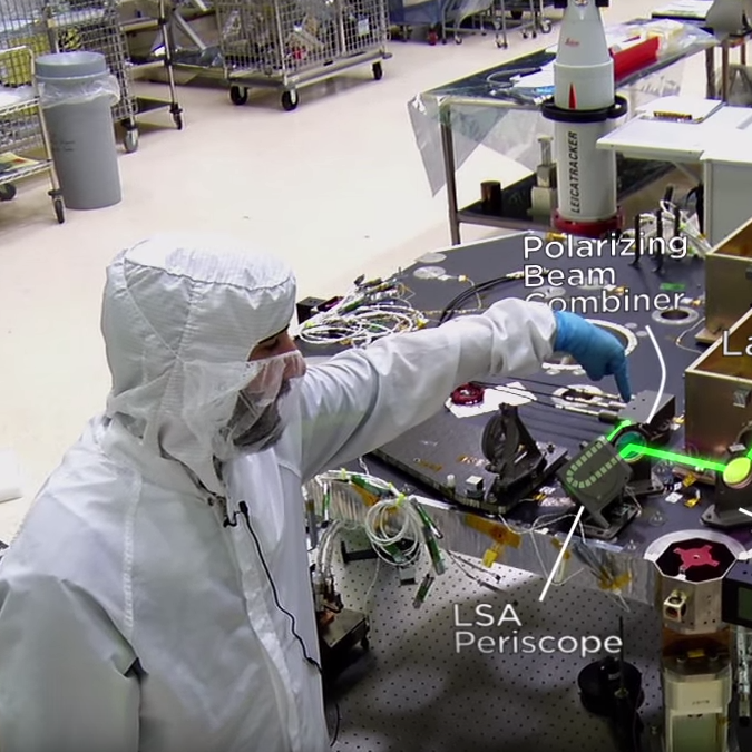 man pointing at polarizing beam combiner